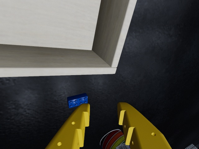 Wrist camera: the gripper's fingers, the brick ahead and the box to the left