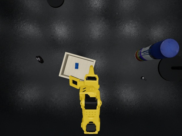 Overhead camera: the brick inside the wooden box, the arm withdrawn