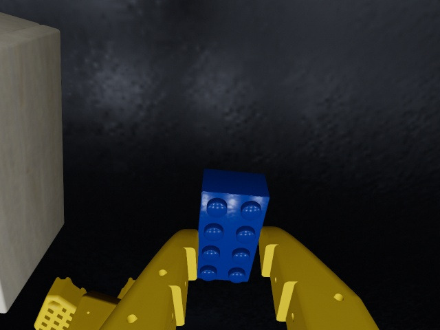 Wrist camera: the blue brick held between the gripper's fingers