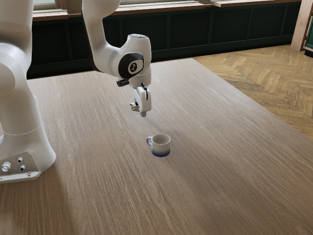 Front camera: the arm over the table, the mug standing